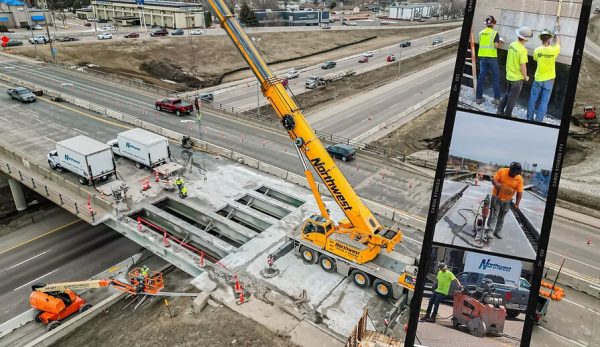 Construction workers operating on a highway, accompanied by a crane and a truck, illustrating active road construction.